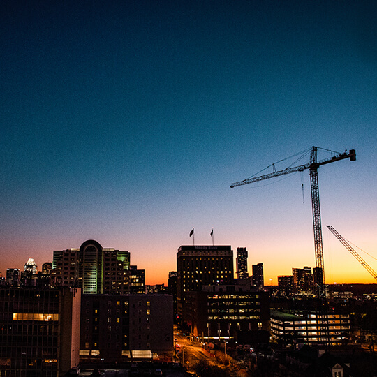 Denton skyline and crane at sunset