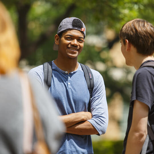 Smiling students talking outside